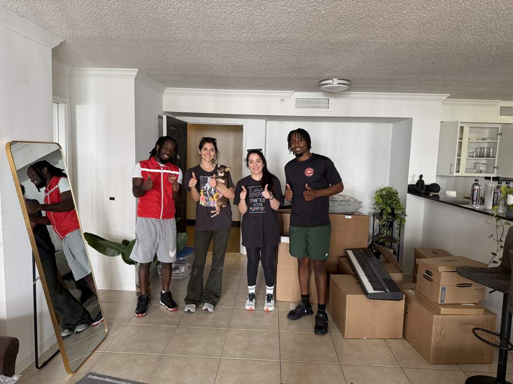 The Up and Up Movers crew with two customers at the end of a South Florida move